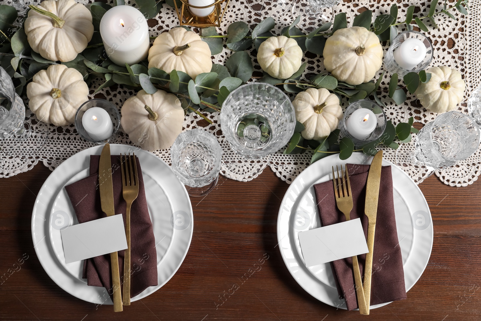 Photo of Beautiful autumn table setting. Plates, cutlery, glasses, blank cards and floral decor, flat lay