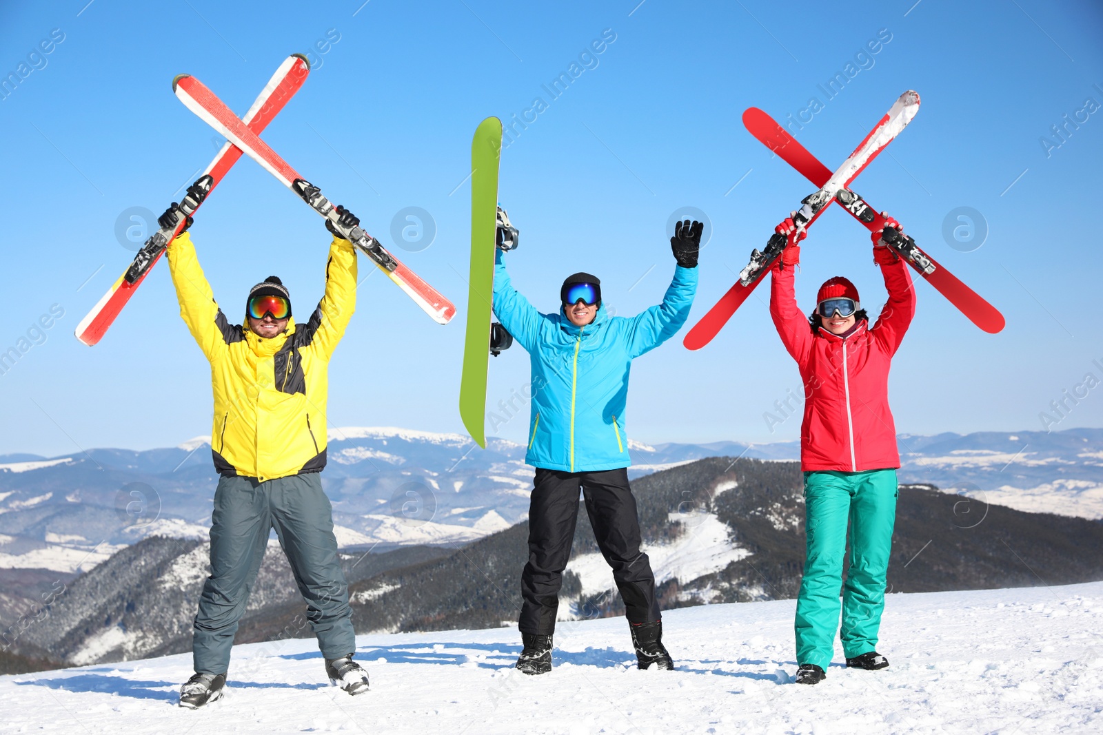 Photo of Friends with equipment at ski resort. Winter vacation