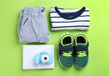 Flat lay composition with little photographer's toy camera on light green background