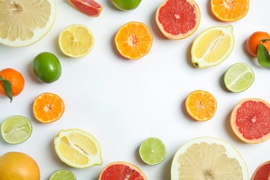 Different citrus fruits on white background, flat lay. Space for text