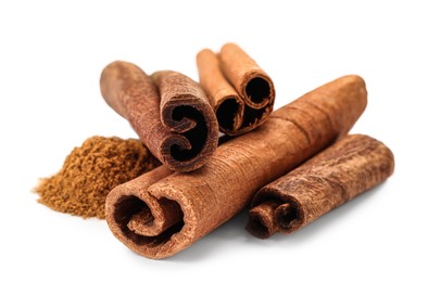 Dry aromatic cinnamon sticks and powder isolated on white