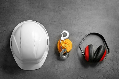 Photo of Flat lay composition with safety equipment on grey background