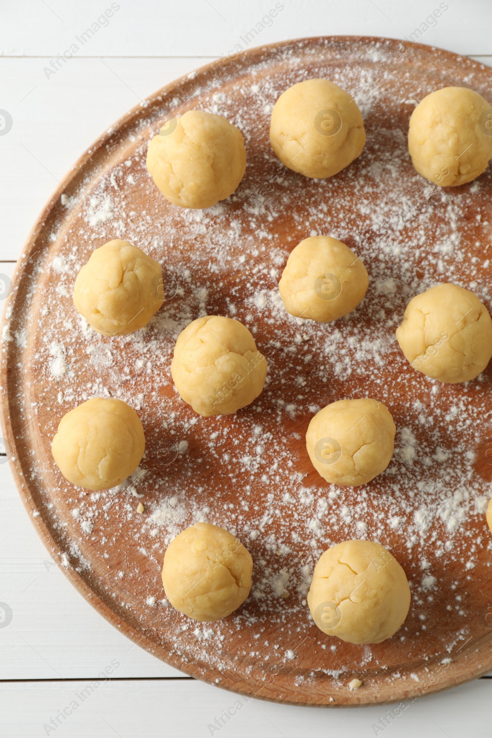 Photo of Shortcrust pastry. Raw dough balls on white wooden table, top view