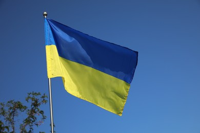 Photo of National flag of Ukraine against blue sky