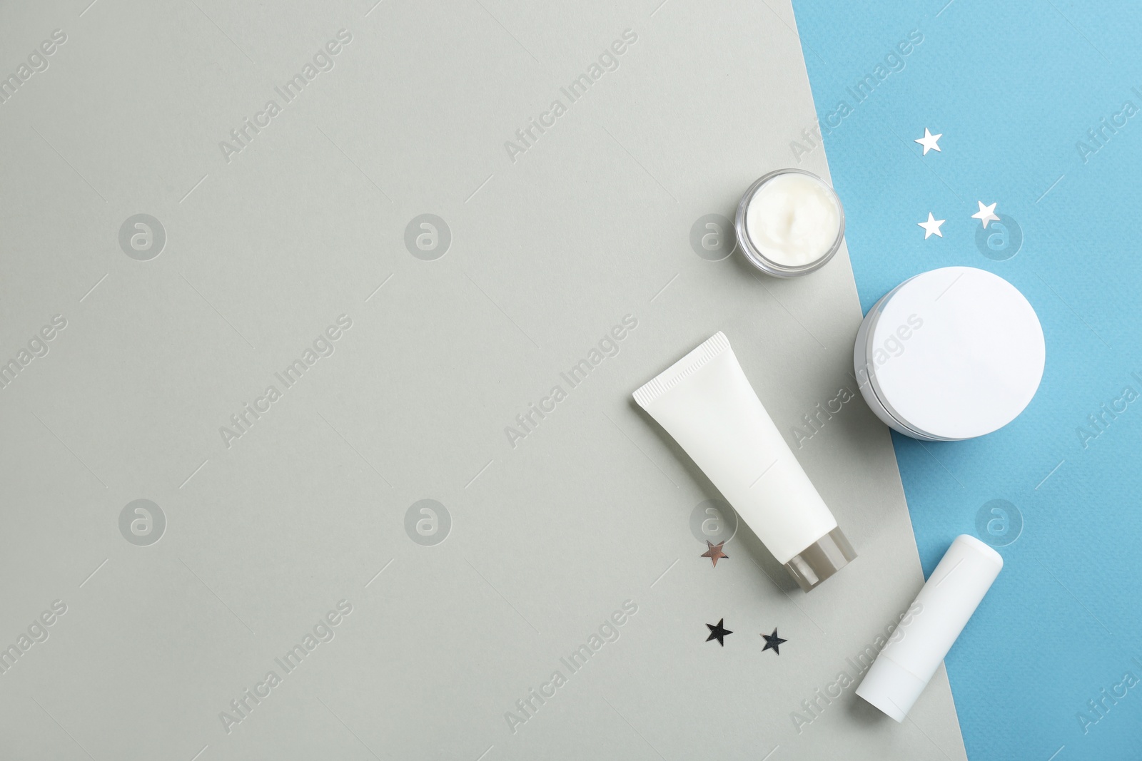 Photo of Flat lay composition with different cosmetic products on color background, space for text. Winter care