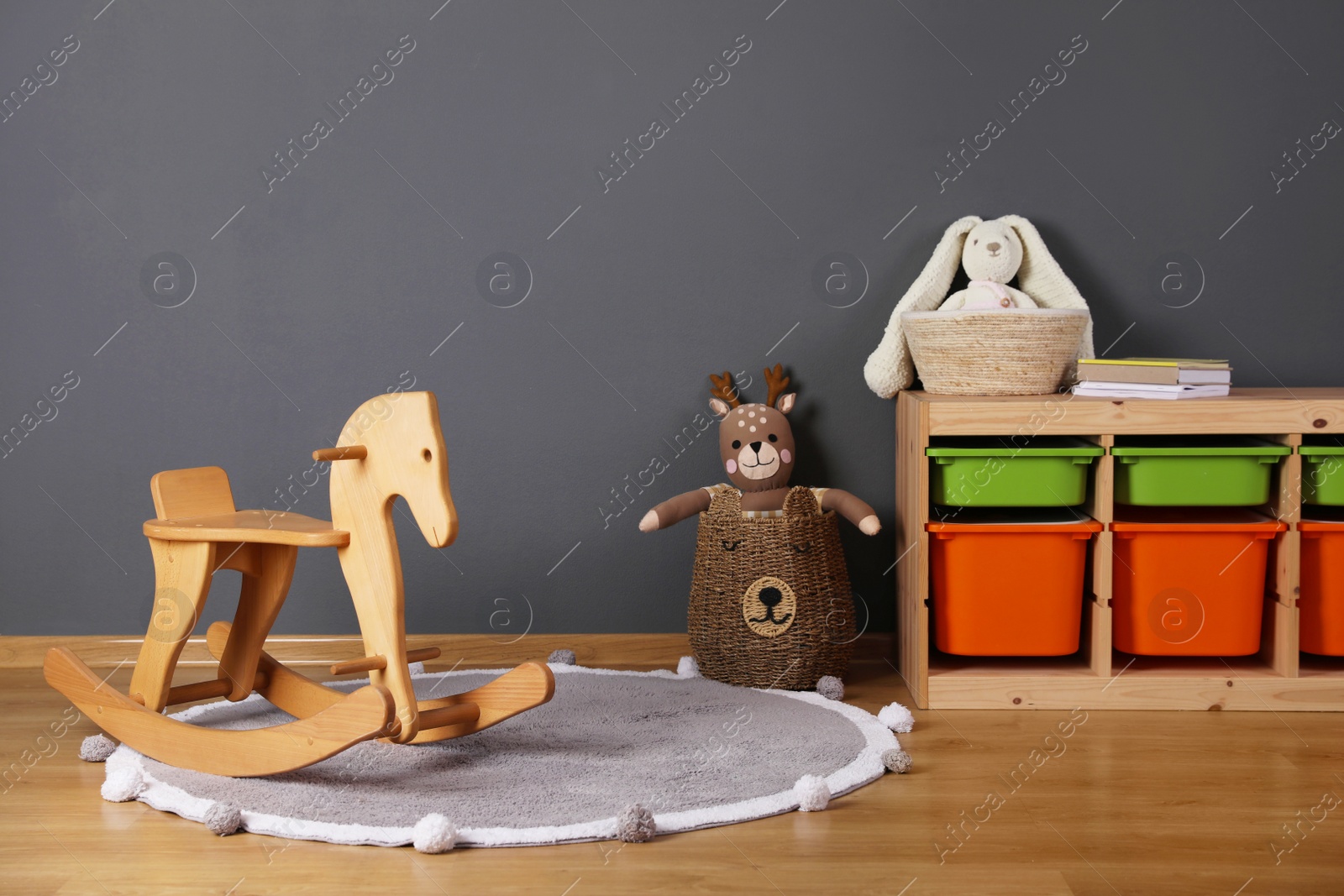 Photo of Child's room interior with rocking horse and different toys