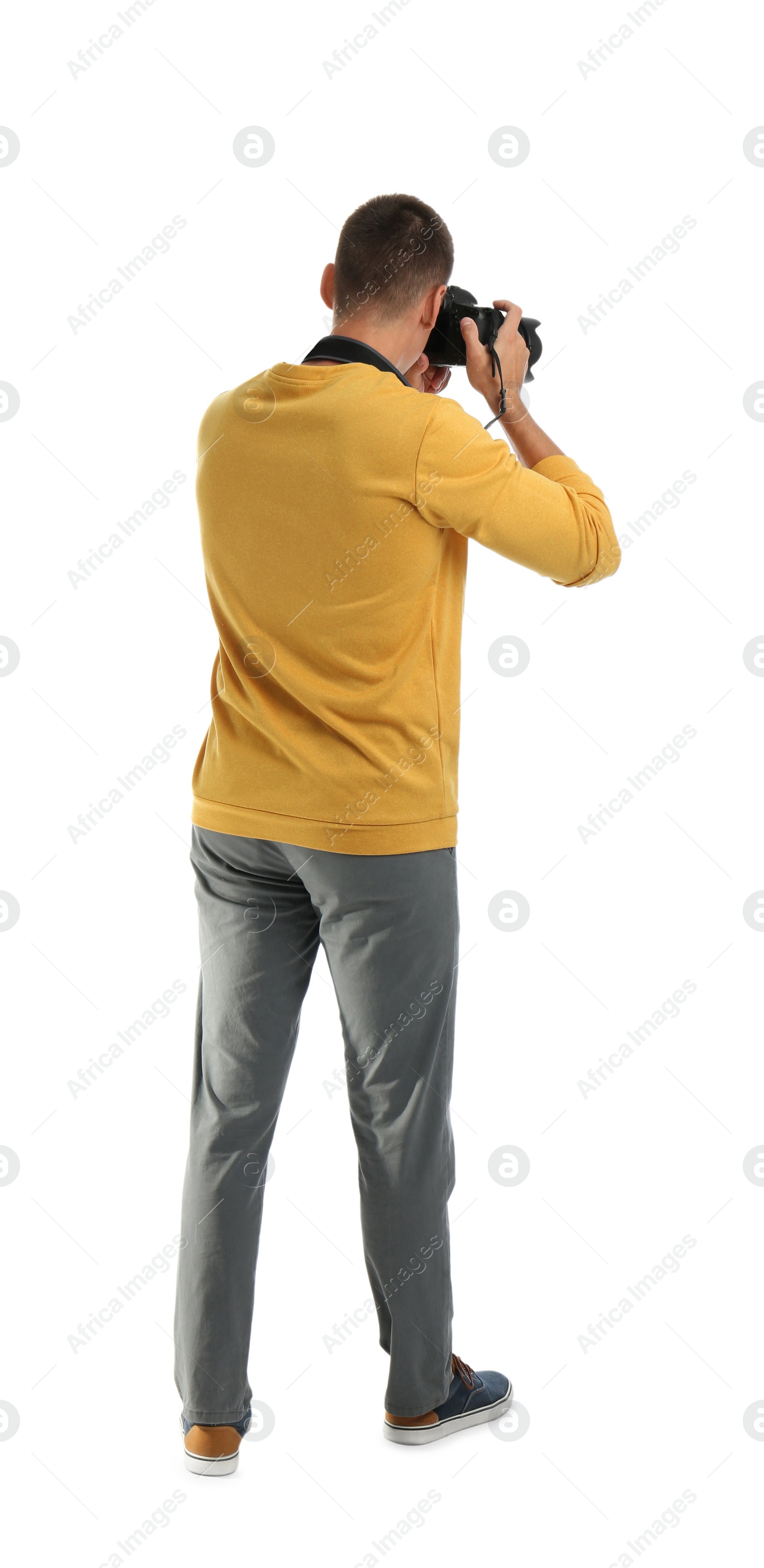 Photo of Young photographer with professional camera on white background, back view