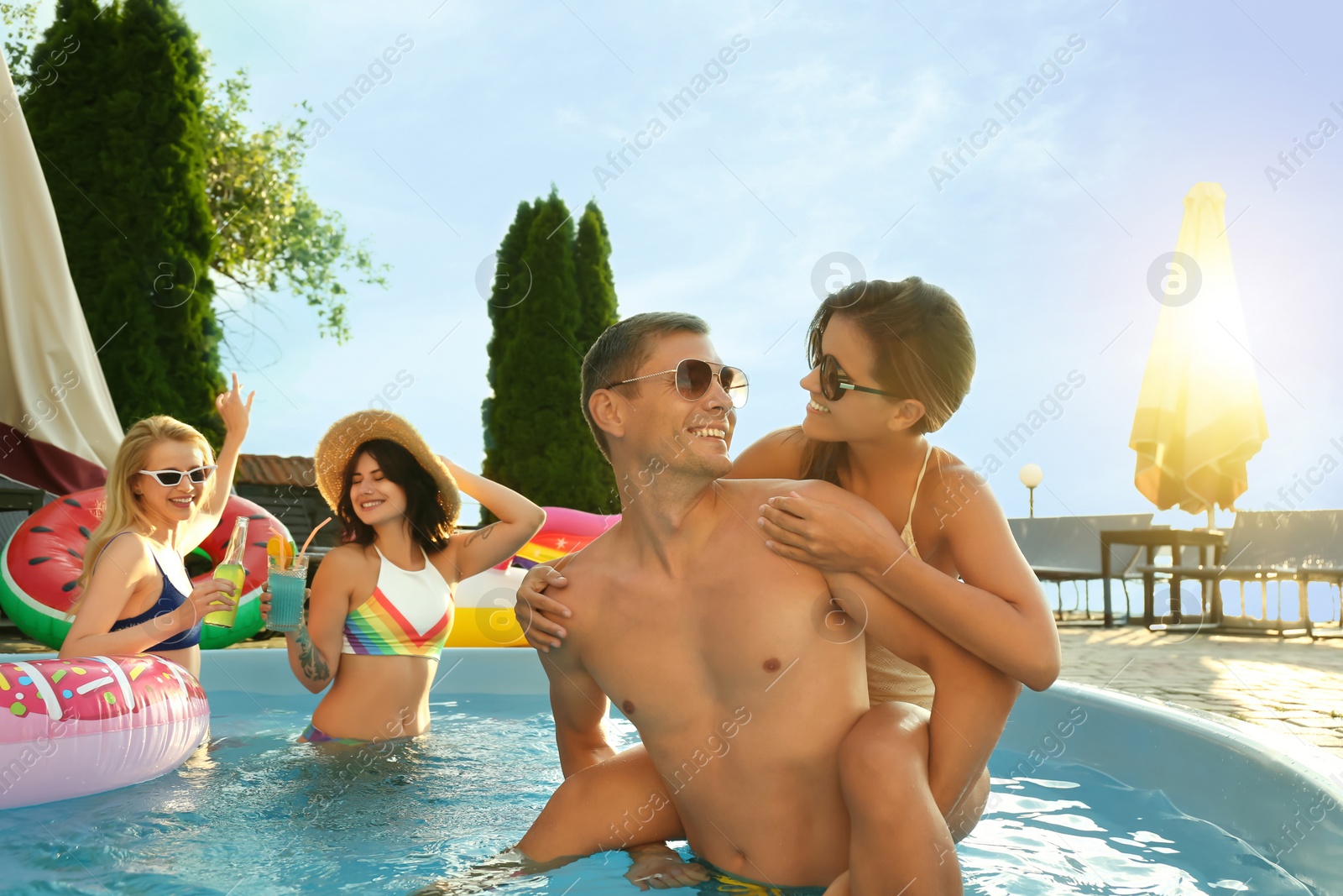 Photo of Group of happy people enjoying fun pool party