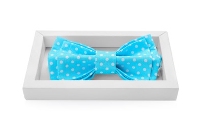 Photo of Stylish light blue bow tie with polka dot pattern in box on white background