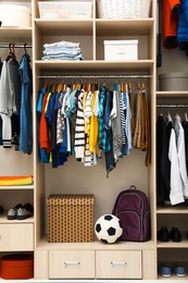 Photo of Large wardrobe with teenager clothes, shoes and accessories