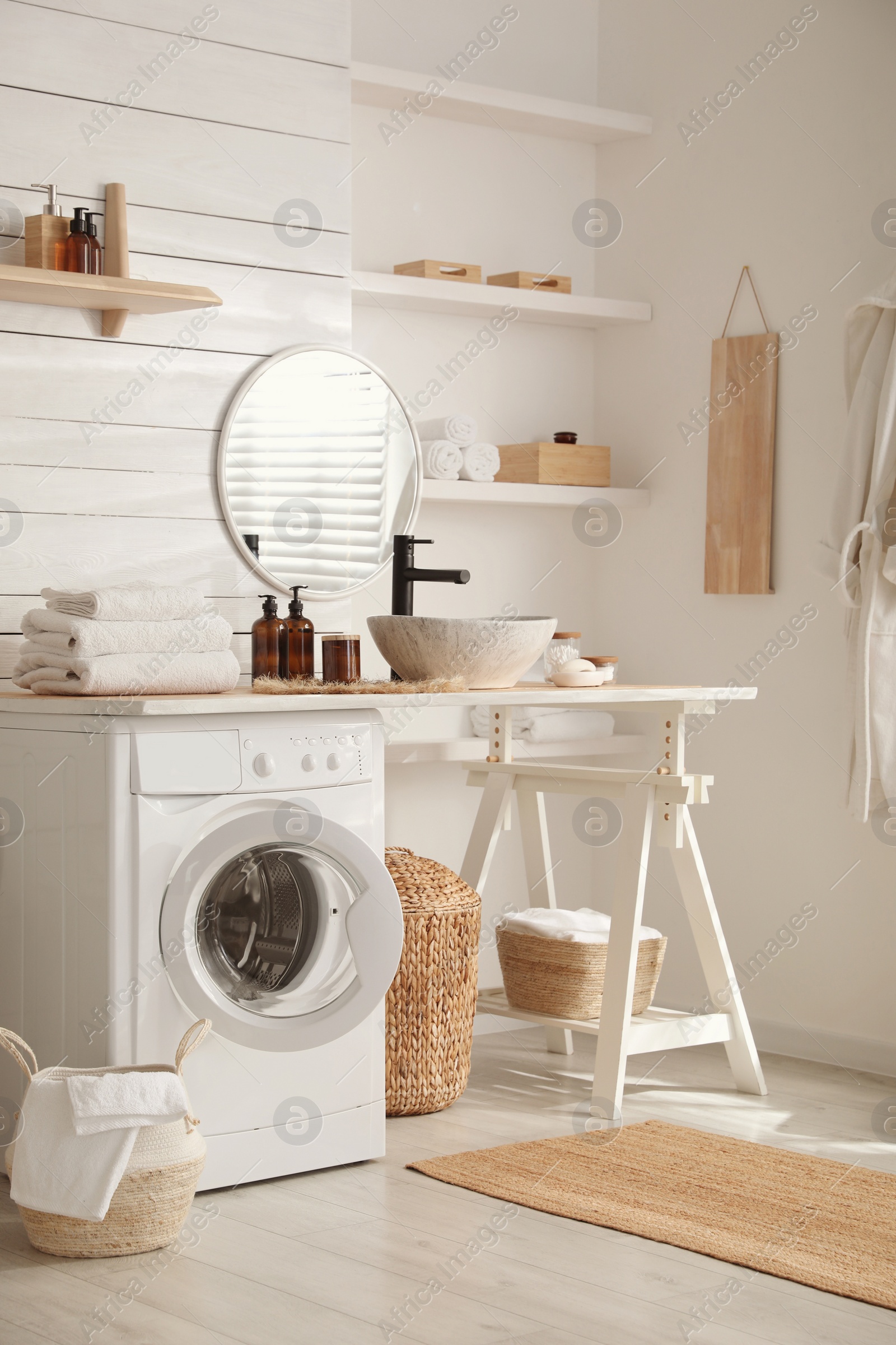 Photo of Stylish bathroom interior with modern washing machine