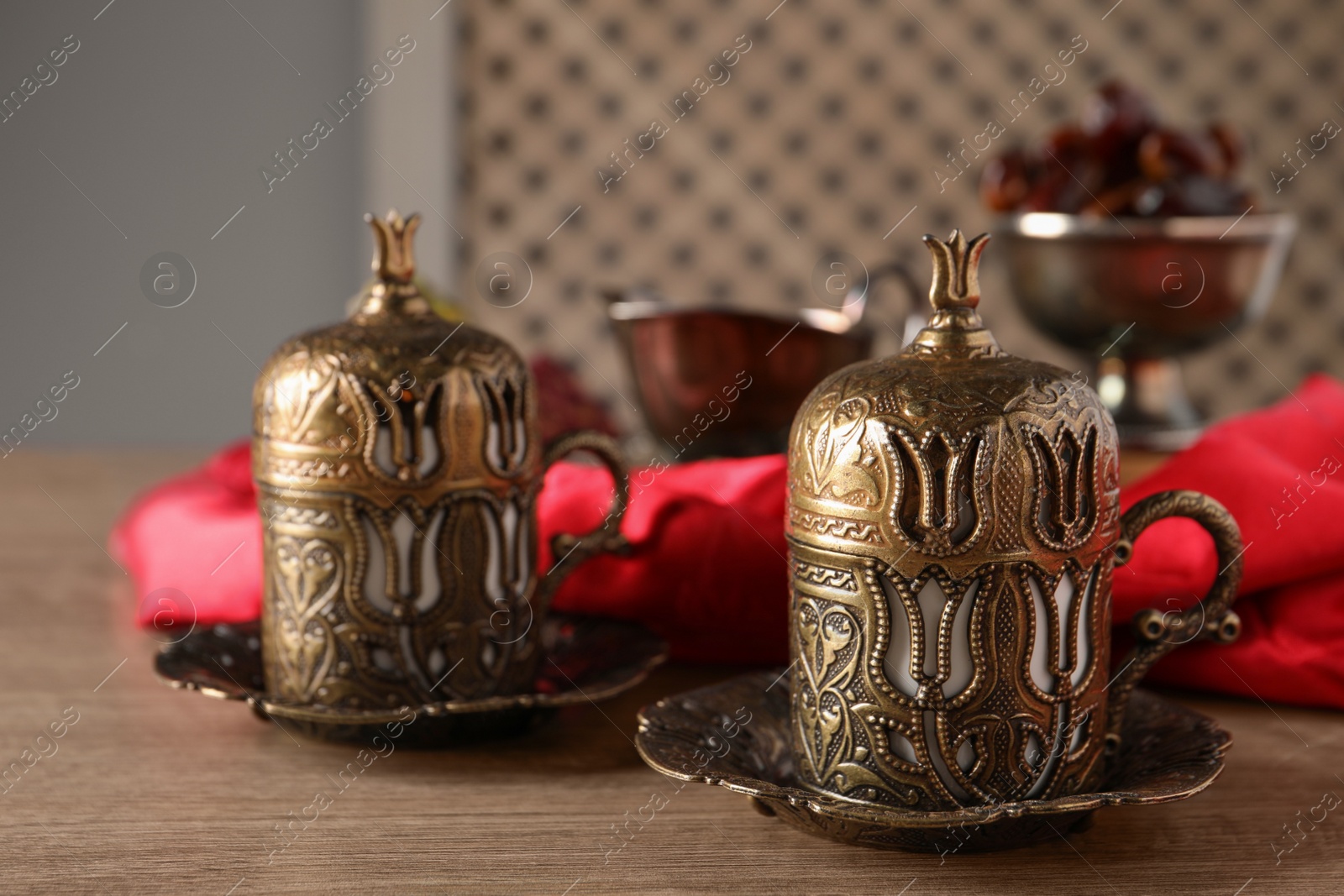 Photo of Beautiful vintage cup holders on wooden table