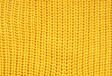 Texture of cozy warm sweater as background, closeup