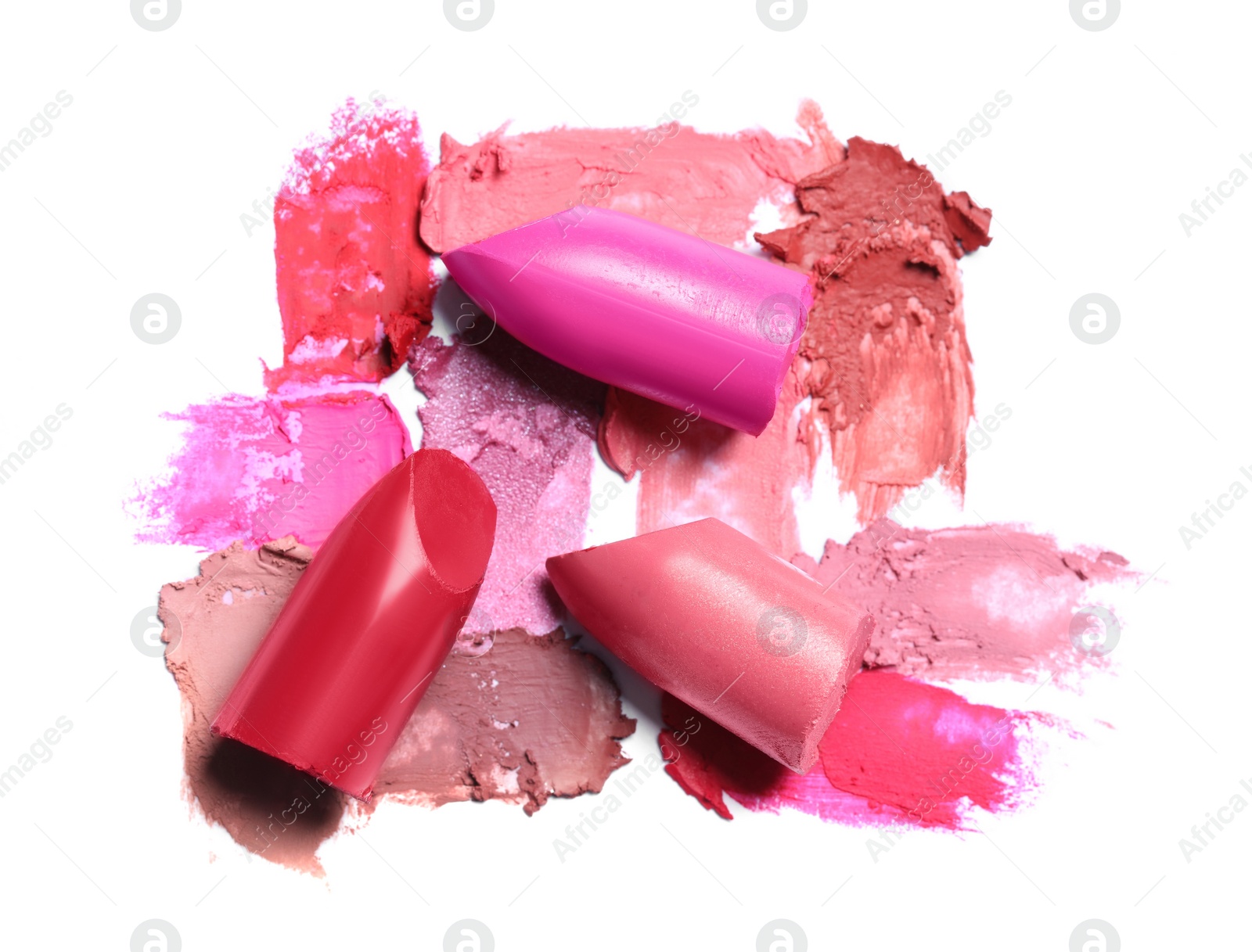 Photo of Different lipsticks and smears on white background, top view