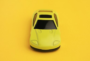 Photo of One bright car on yellow background. Children`s toy