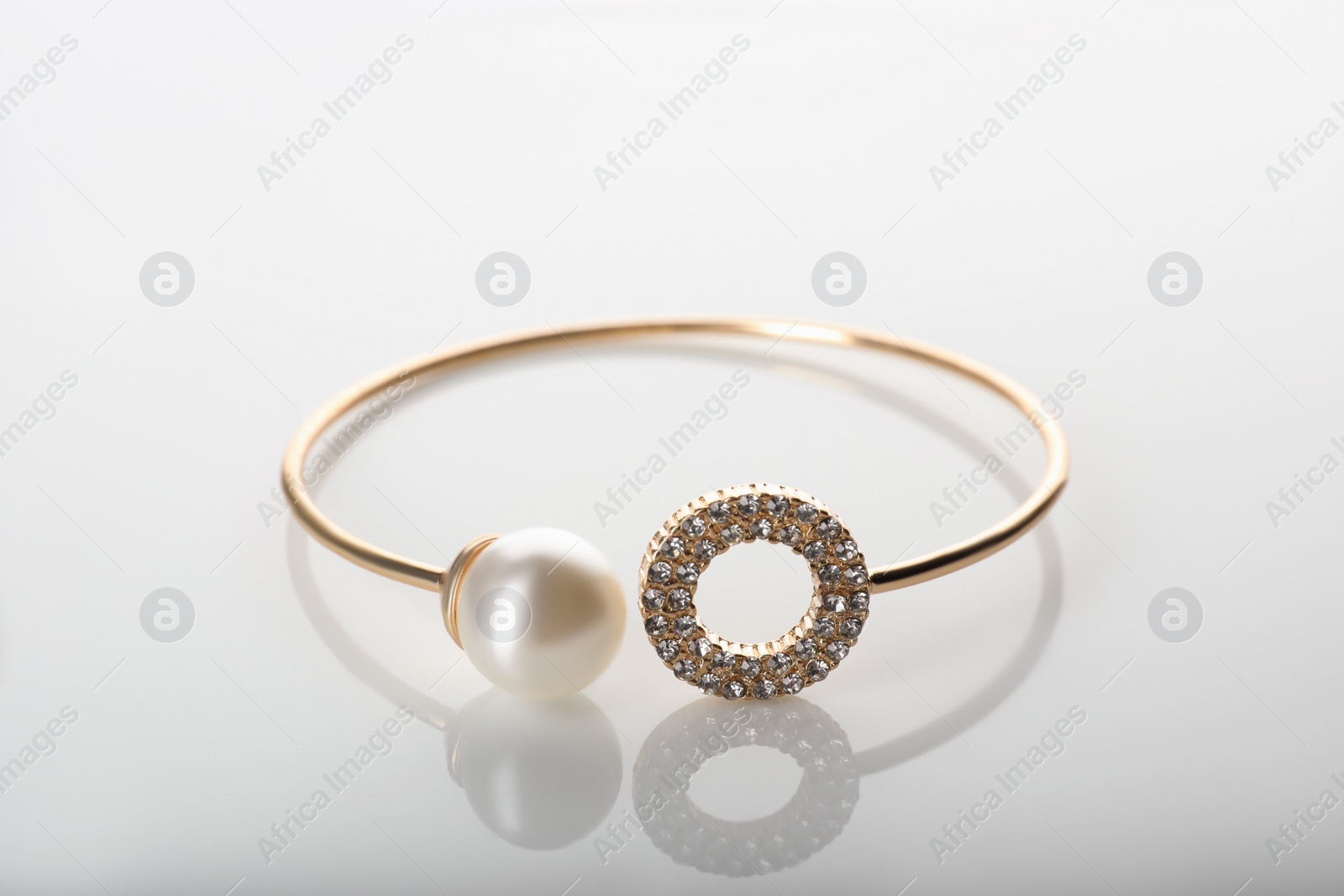 Photo of Elegant golden bracelet with pearl isolated on white