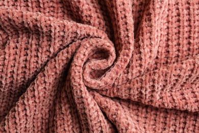 Beautiful pink knitted fabric as background, top view