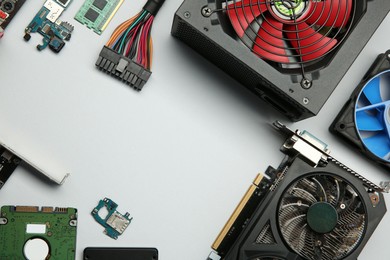 Photo of Graphics card and other computer hardware on light background, flat lay. Space for text