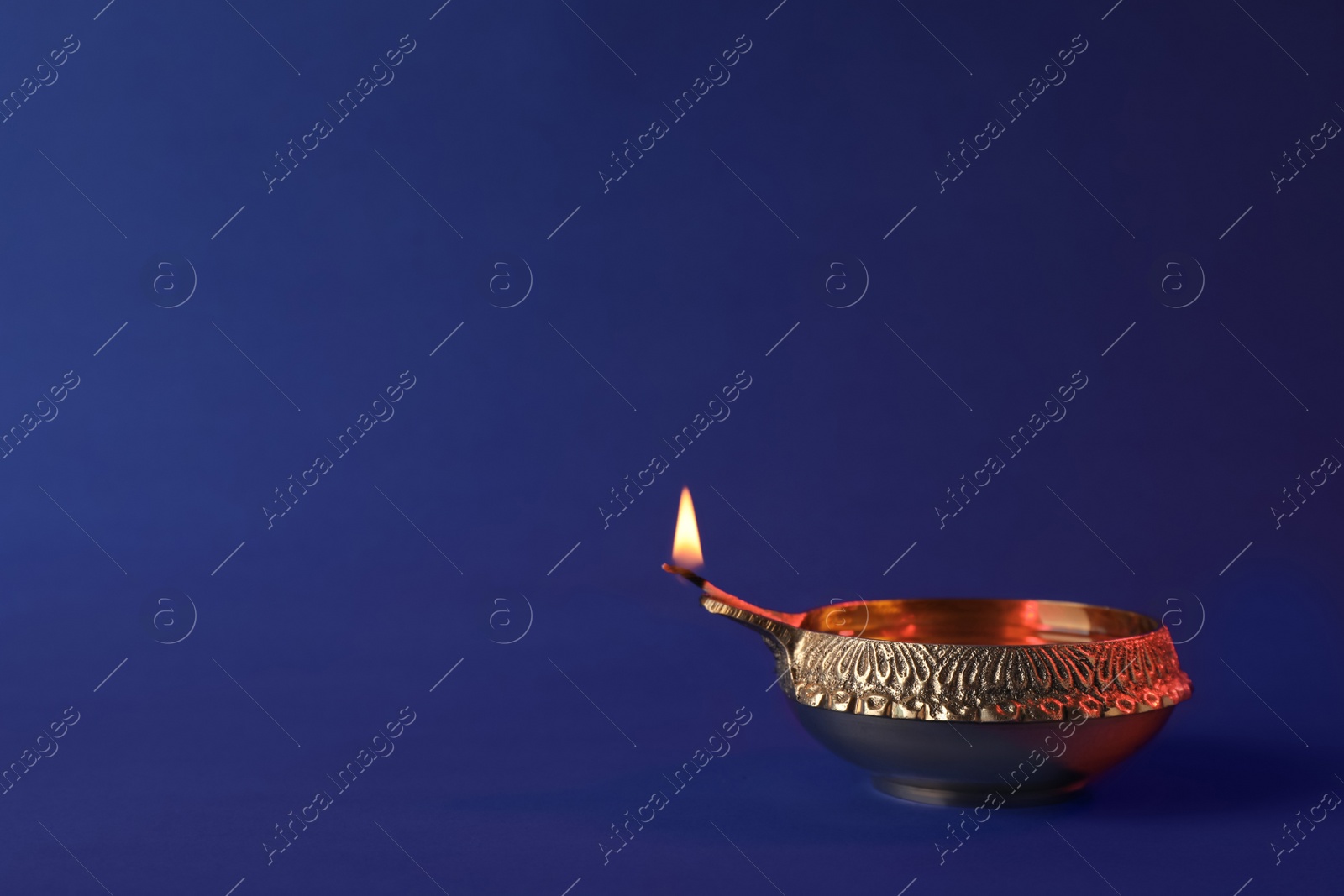 Photo of Diwali diya or clay lamp on color background