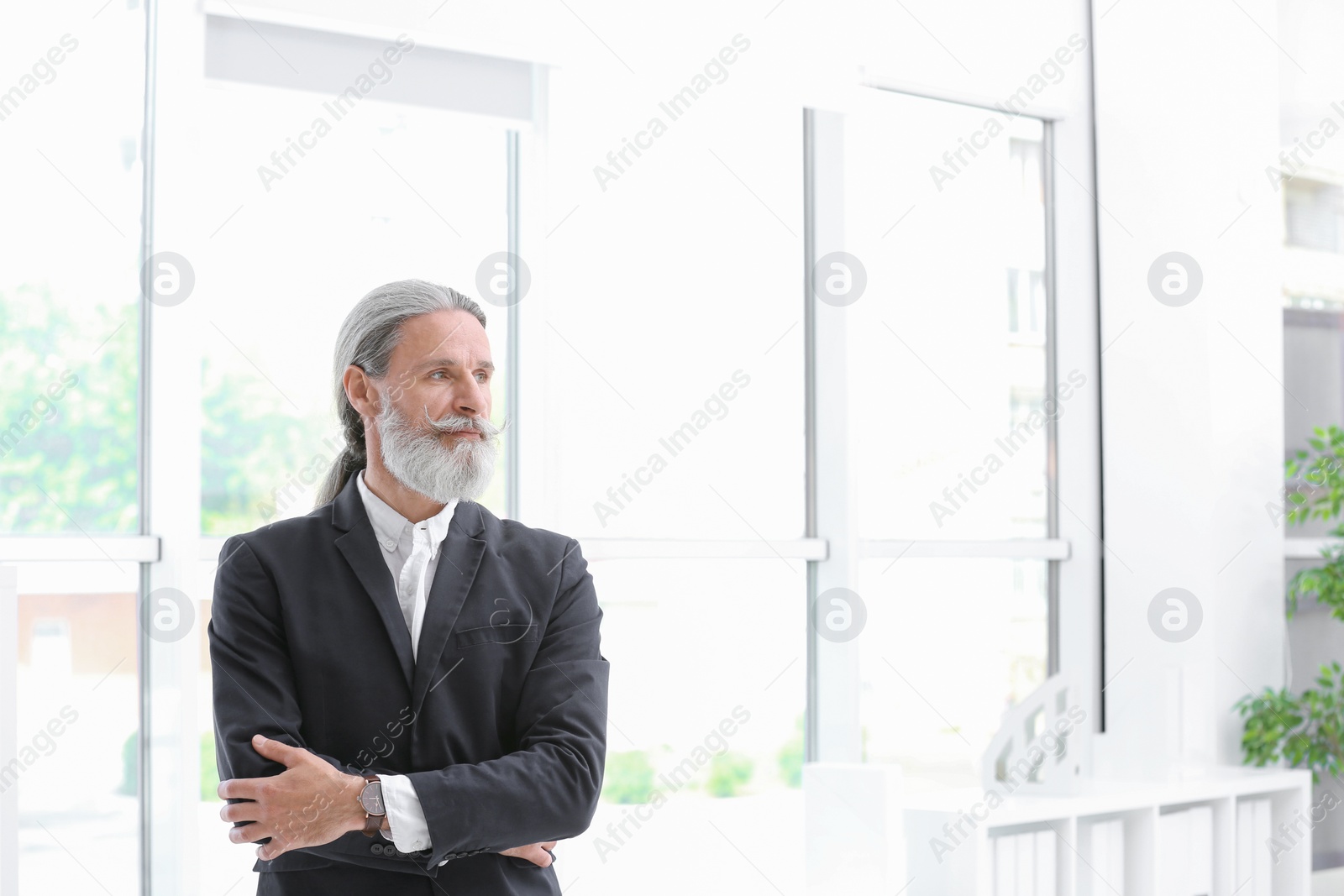 Photo of Portrait of handsome mature man in suit, indoors