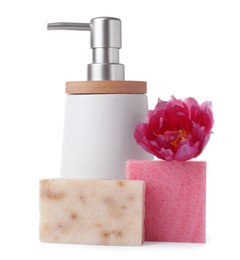 Soap bars, dispenser and pink flower on white table