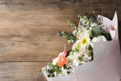 Bouquet of beautiful flowers on wooden table, top view. Space for text