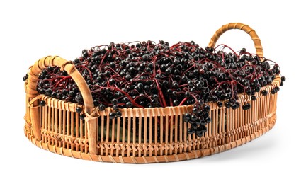 Photo of Wicker basket with ripe elderberries isolated on white