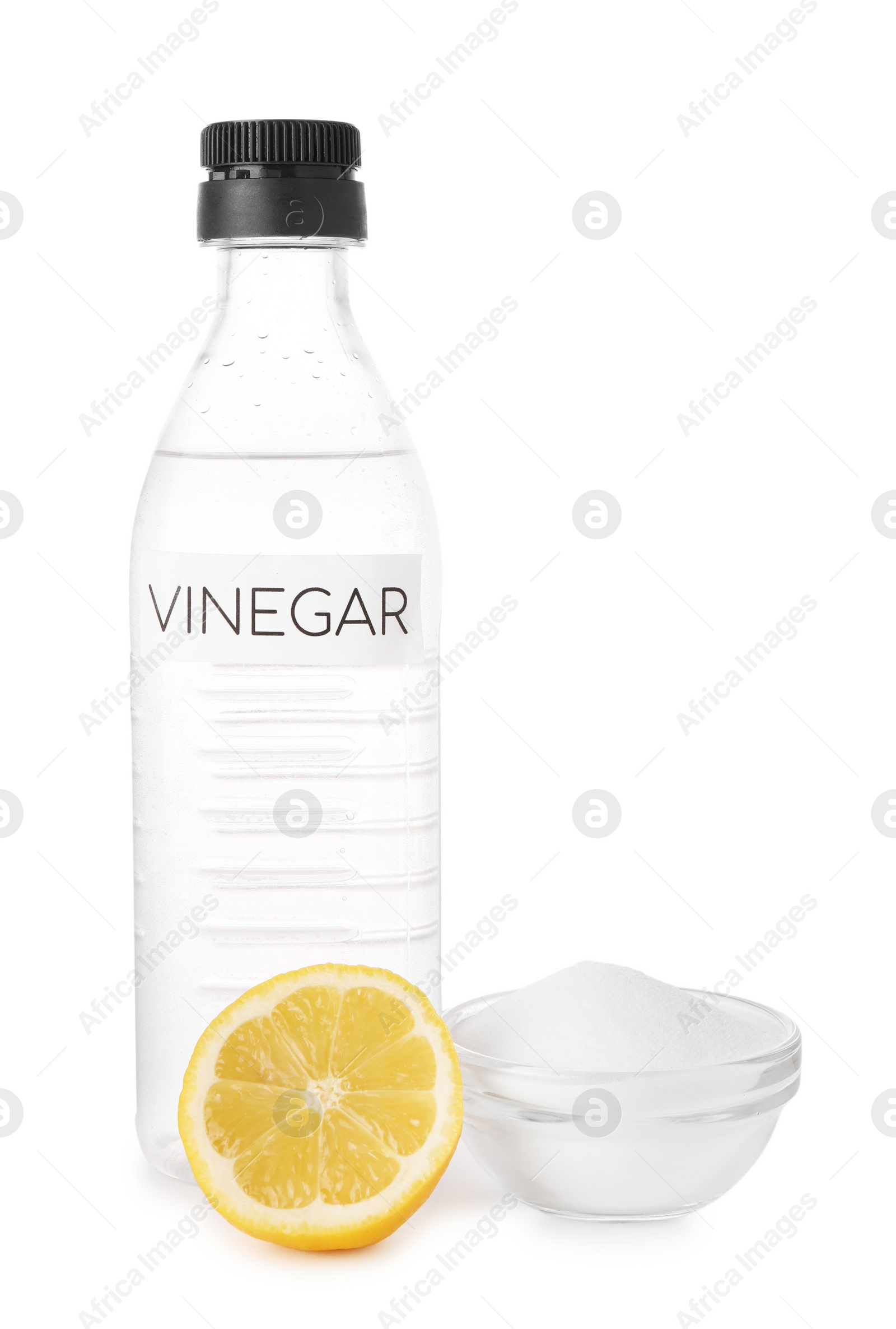 Photo of Eco friendly natural cleaners. Vinegar in bottle, cut lemon and bowl of soda isolated on white