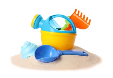 Photo of Plastic beach toys on pile of sand, white background