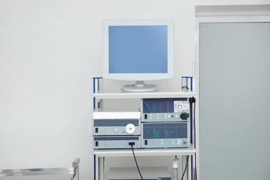 Photo of Modern endoscope in diagnostic room. Space for text