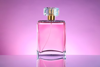 Luxury women's perfume in bottle on violet background