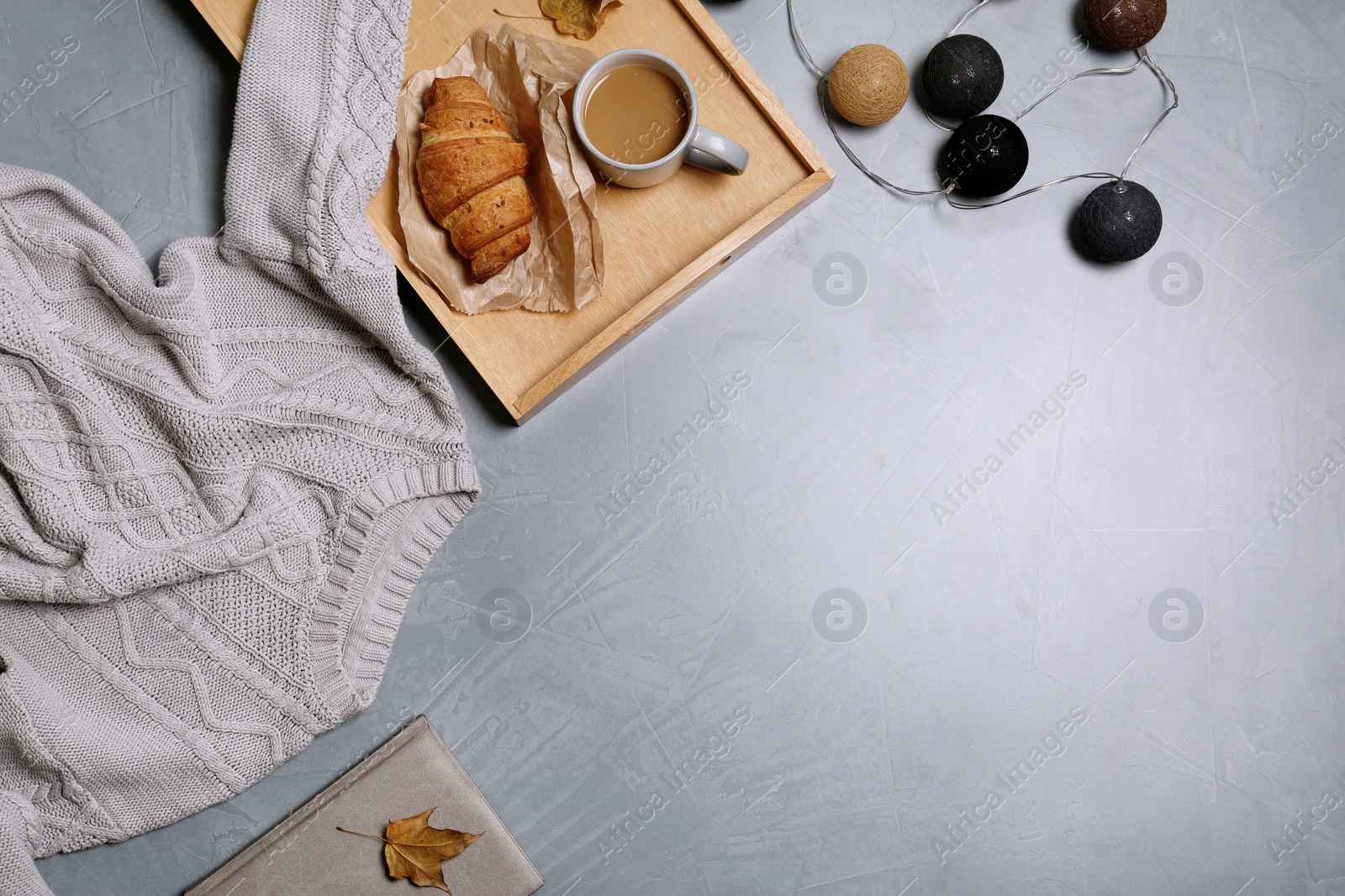 Photo of Flat lay composition with warm sweater and space for text on color background