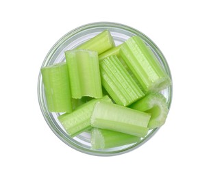 Photo of Glass bowl of fresh cut celery isolated on white, top view