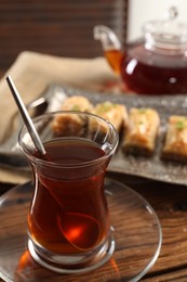 Traditional Turkish tea in glass on wooden table
