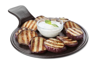 Photo of Slate plate of delicious grilled eggplant slices with sauce isolated on white