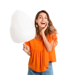 Emotional young woman with cotton candy on white background