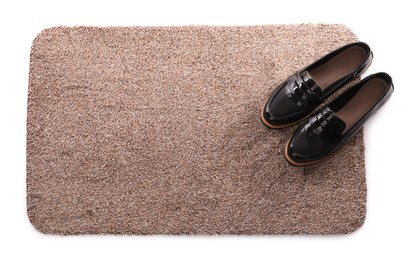 Photo of Stylish door mat with shoes on white background, top view