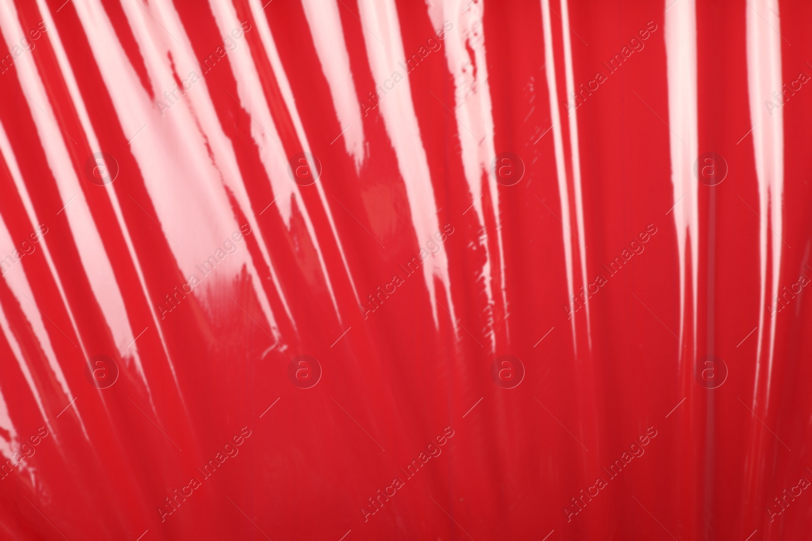 Photo of Red plastic stretch wrap as background, top view