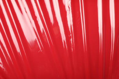 Photo of Red plastic stretch wrap as background, top view