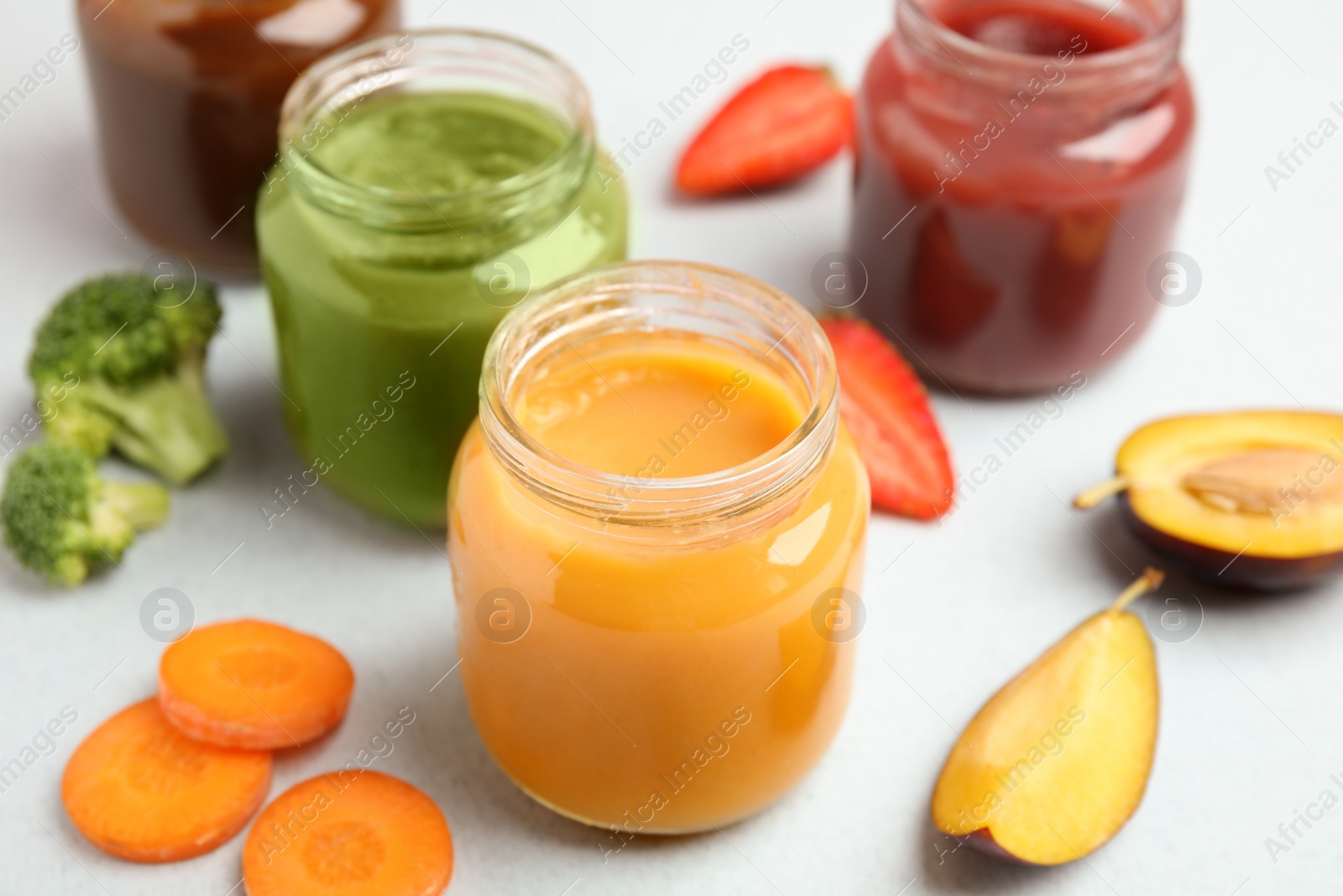 Photo of Healthy baby food and ingredients on grey background