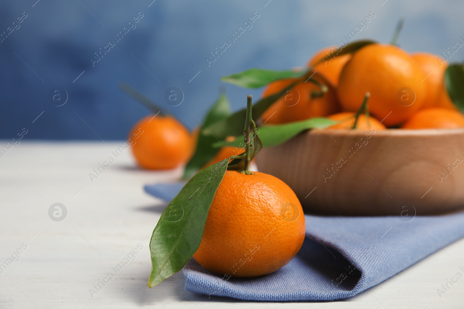 Photo of Fresh ripe tangerines on table. Space for text