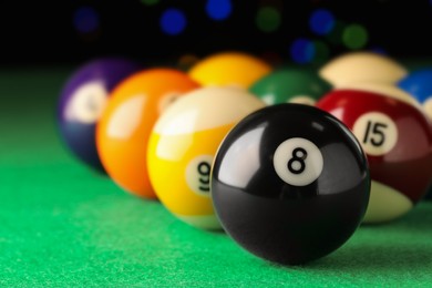 Photo of Many colorful billiard balls on green table, closeup. Space for text