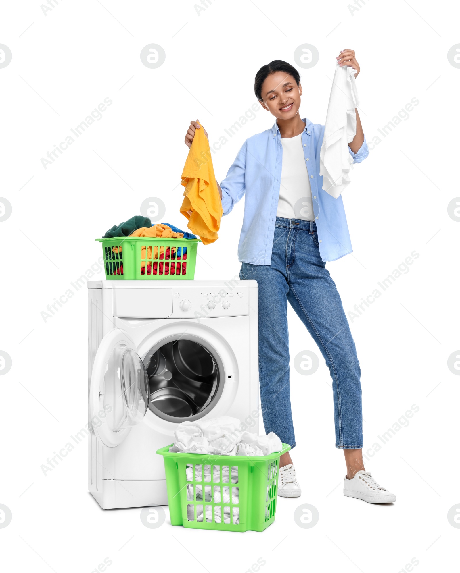 Photo of Beautiful woman with laundry near washing machine on white background