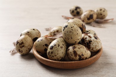 Photo of Fresh quail eggs on white wooden table
