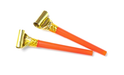 Photo of Orange party blowers on white background, top view