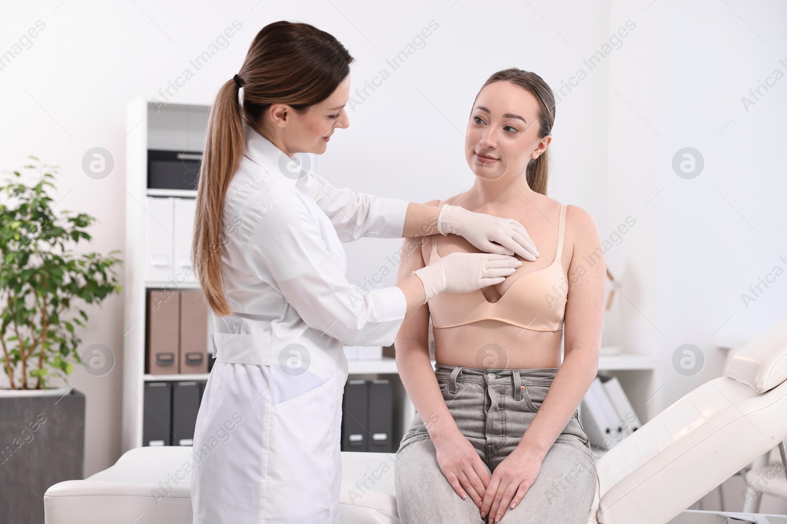 Photo of Mammologist checking young woman's breast in hospital