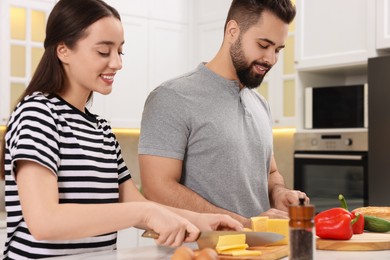 Photo of Lovely young couple cooking together in kitchen