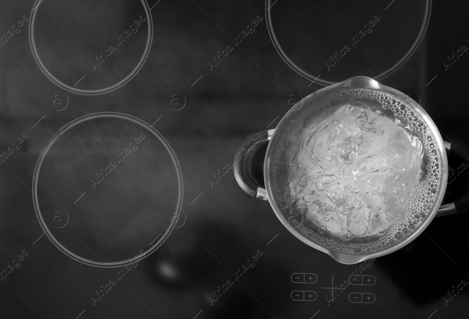 Photo of Pot with boiling water on stove, top view. Space for text