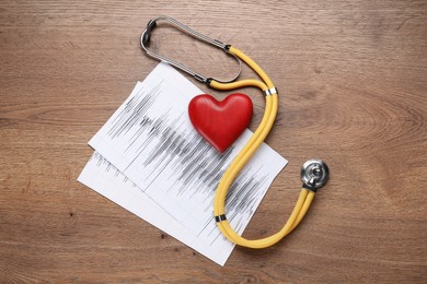 Stethoscope, red heart and cardiogram on wooden table, flat lay. Cardiology concept