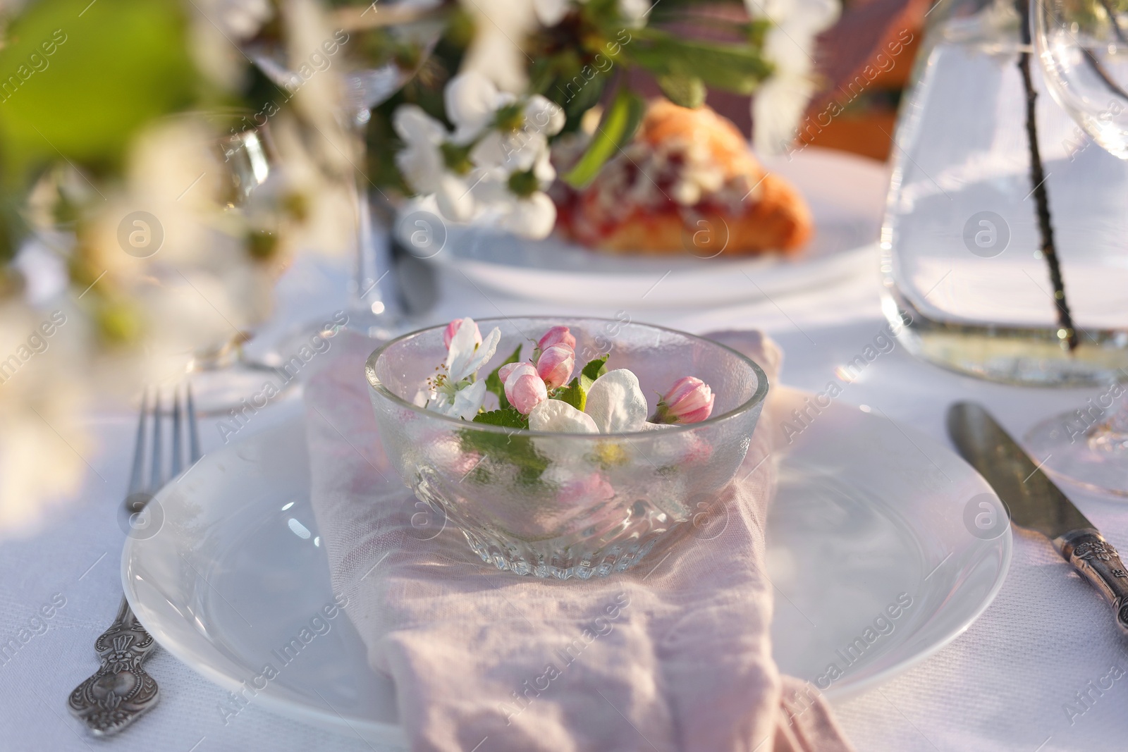 Photo of Stylish table setting with beautiful spring flowers in garden